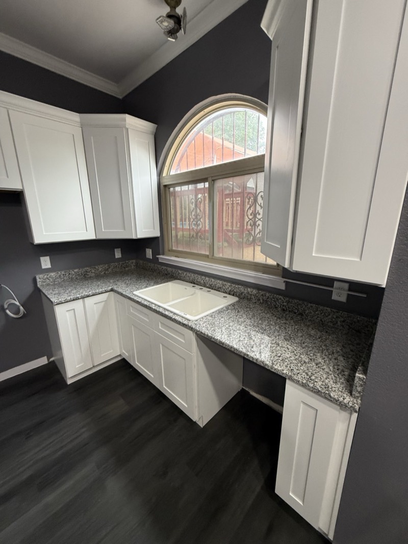 White shaker kitchen cabinets with an arched window in an Atlanta home