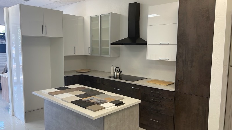 Modern high-gloss white and dark wood-grain European display cabinets in the Norcross showroom