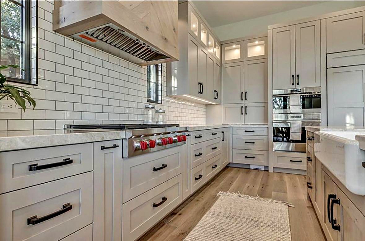 Greige shaker kitchen cabinets with subway tile backsplash showing a full cabinet run in an Atlanta home