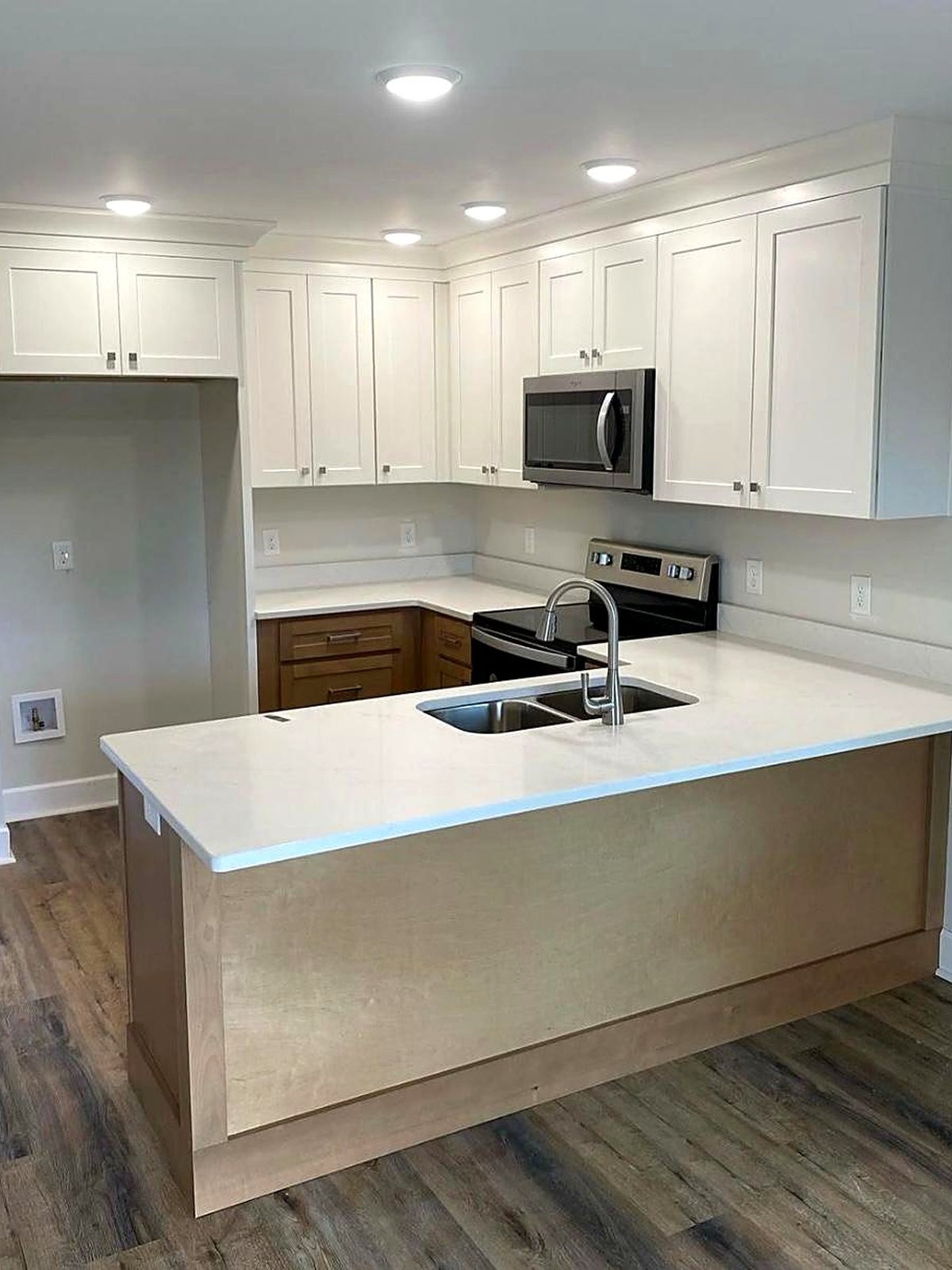 Compact white shaker kitchen with a maple peninsula, a small-kitchen layout idea for metro Atlanta homes