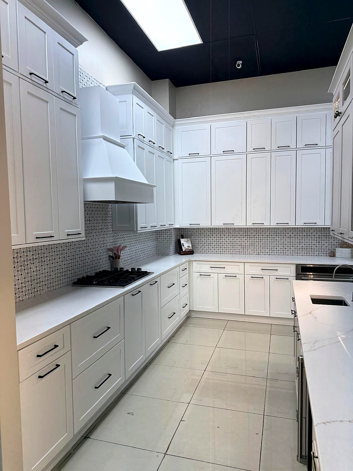 White shaker U-shaped kitchen with black hardware built from standard-size cabinets in a metro Atlanta home