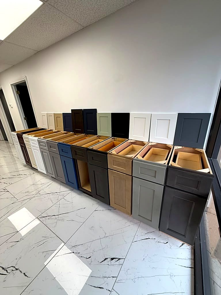 Lineup of assembled shaker base cabinets in different finishes at the MNK Cabinet showroom in Norcross GA