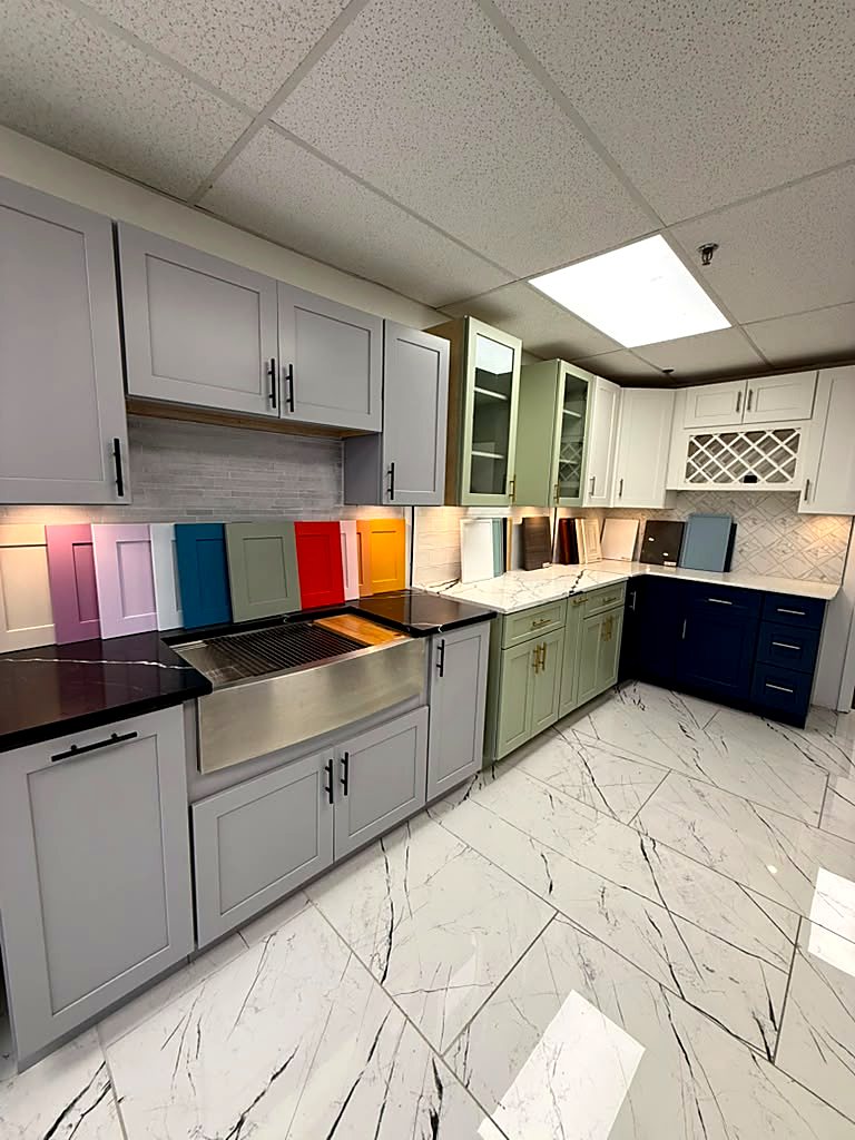 Sage, navy and gray shaker cabinet displays inside MNK Cabinet's factory-direct kitchen cabinet showroom in Norcross, GA