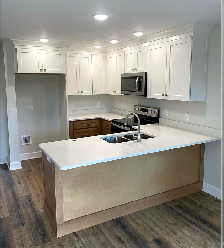 Tall pantry and storage cabinets in a white shaker kitchen