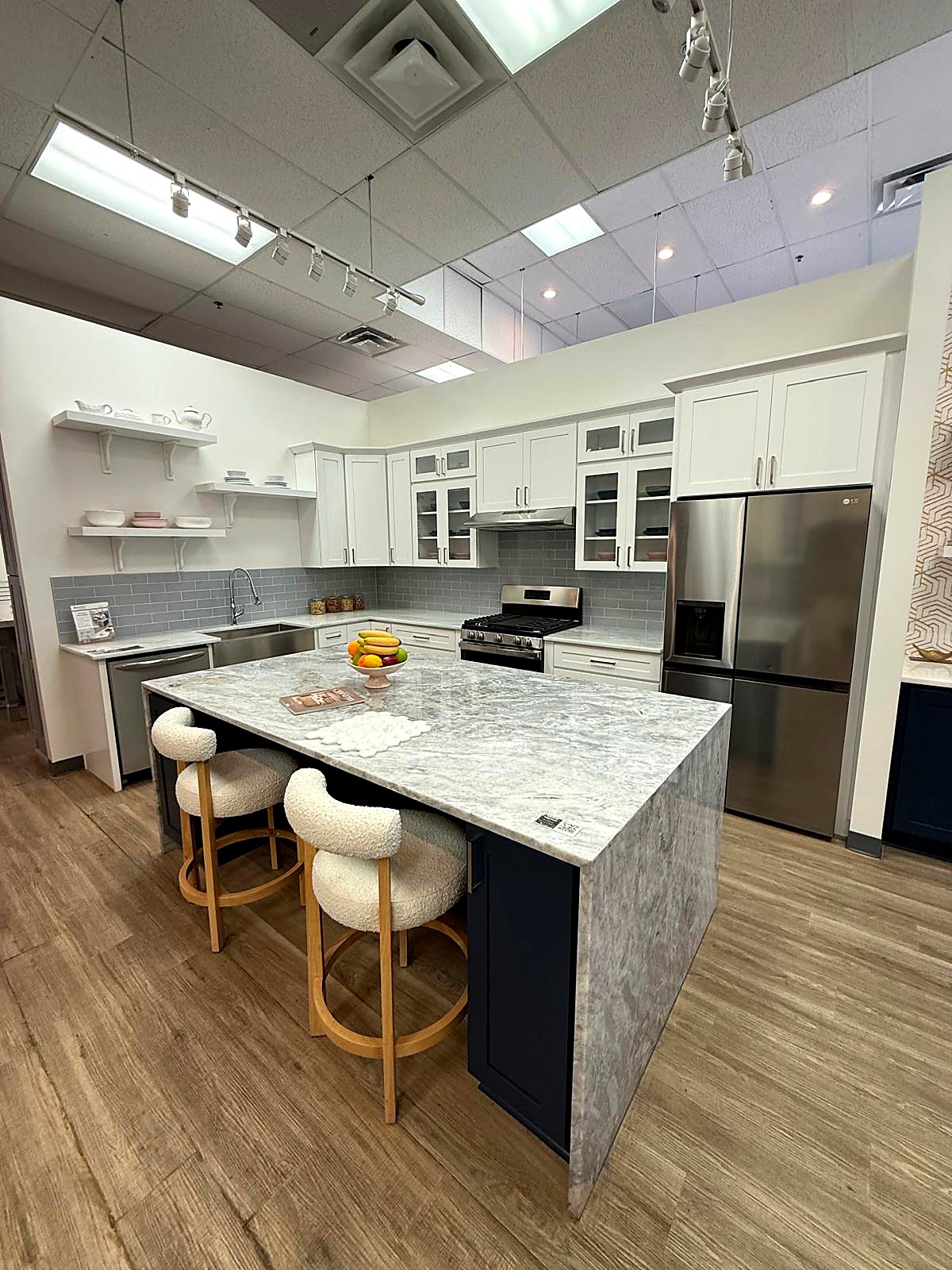 White shaker kitchen cabinets with a navy island and waterfall counter in Atlanta