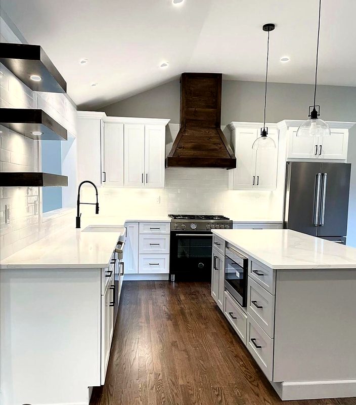 Finished white shaker kitchen with white quartz countertops, oversized white island — kitchen by MNK Cabinet in metro Atlanta